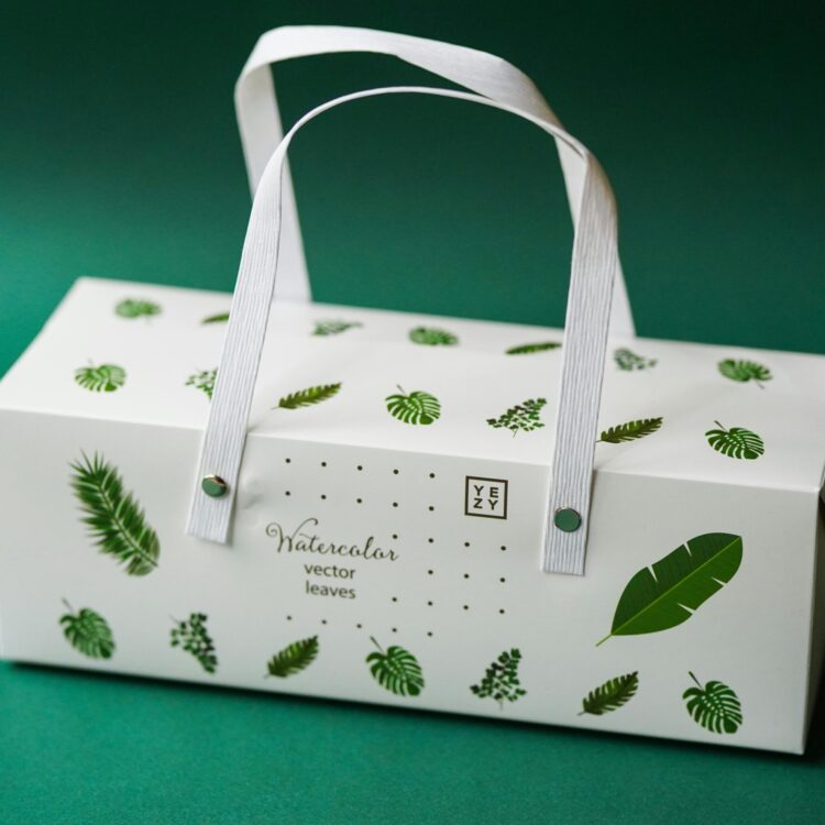 Elegant packaging box featuring watercolor leaf design on a green background.