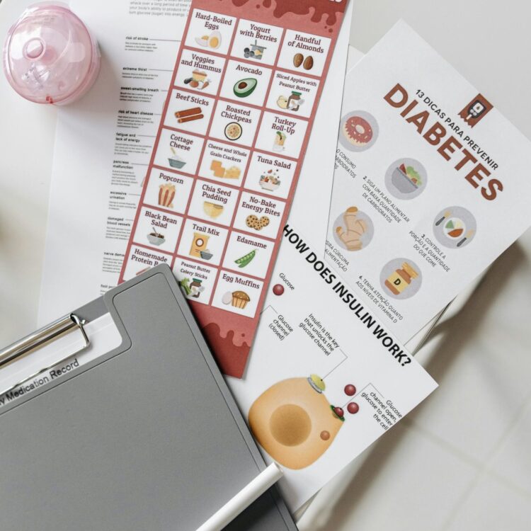 Top view of diabetes educational flyers on a table with a notepad and pen, offering health insights.