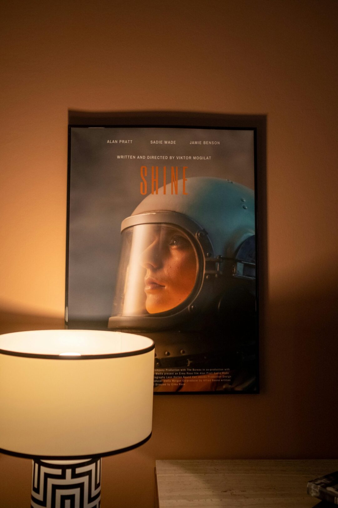 Warm home interior featuring an astronaut poster beside a stylish lamp.