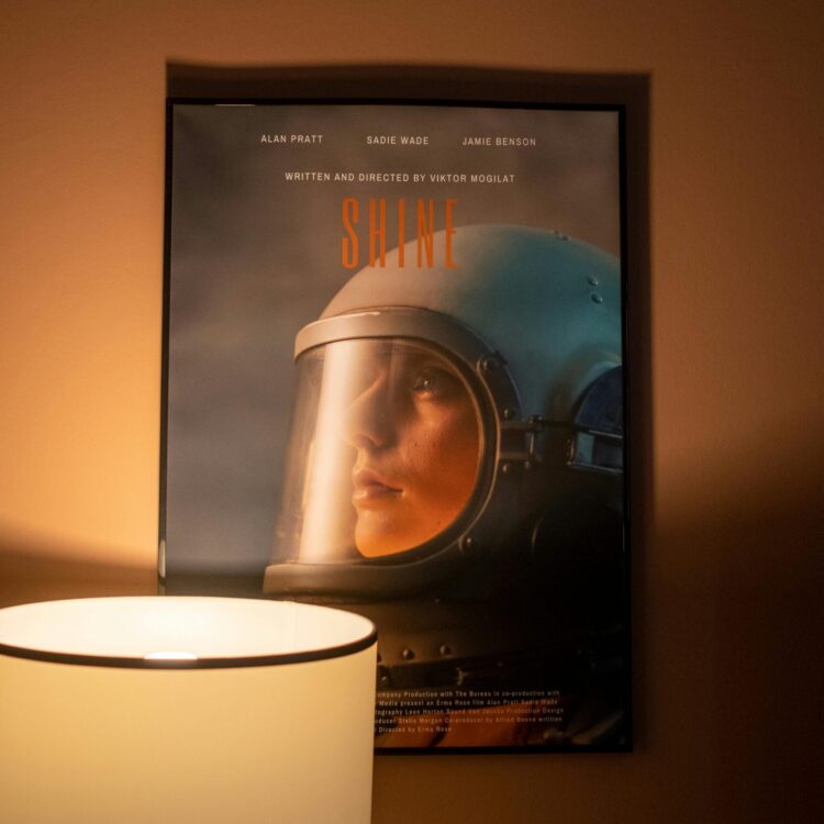 Warm home interior featuring an astronaut poster beside a stylish lamp.